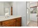 Bathroom features a vanity with wood cabinets, a white countertop, and a glass door shower at 10119 E Winter Sun Dr, Scottsdale, AZ 85262