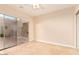 Bedroom with tile floors features an exterior sliding glass door for backyard access at 10119 E Winter Sun Dr, Scottsdale, AZ 85262