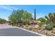 Community sign surrounded by desert landscaping and stone details at the gated entrance at 10119 E Winter Sun Dr, Scottsdale, AZ 85262
