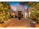 Inviting courtyard with brick pavers, lush landscaping, and ambient lighting creates a tranquil and elegant outdoor oasis at 10119 E Winter Sun Dr, Scottsdale, AZ 85262