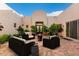 Private courtyard adorned with lush greenery, comfortable seating, and a charming fire pit, creating an inviting outdoor living space at 10119 E Winter Sun Dr, Scottsdale, AZ 85262