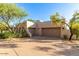 Attractive home exterior with a desert landscape, two garages, and a paver driveway has great curb appeal at 10119 E Winter Sun Dr, Scottsdale, AZ 85262