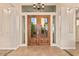 Elegant front entrance featuring double doors with glass panes and detailed flooring at 10119 E Winter Sun Dr, Scottsdale, AZ 85262