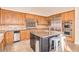 A kitchen featuring stainless steel appliances, wooden cabinets, and an island with a granite countertop at 10119 E Winter Sun Dr, Scottsdale, AZ 85262