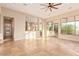 Open living room with tile flooring, a ceiling fan, and large windows providing natural light and views at 10119 E Winter Sun Dr, Scottsdale, AZ 85262