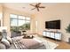 Bright main bedroom with a large window, modern furniture, and tile flooring at 10119 E Winter Sun Dr, Scottsdale, AZ 85262