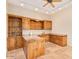 Home office featuring built-in wooden cabinets, a desk, a ceiling fan, and tile flooring at 10119 E Winter Sun Dr, Scottsdale, AZ 85262