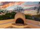 Charming outdoor fireplace with a unique design, perfect for creating a cozy and inviting atmosphere on cool evenings at 10119 E Winter Sun Dr, Scottsdale, AZ 85262
