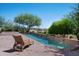 Inviting pool with water features and an outdoor lounge chair for relaxation at 10119 E Winter Sun Dr, Scottsdale, AZ 85262