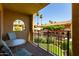 Comfortable balcony features outdoor seating with a view of the well-maintained grounds at 10330 W Thunderbird Blvd # C207, Sun City, AZ 85351