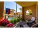 Balcony with outdoor seating overlooking pool and landscaping at 10330 W Thunderbird Blvd # C207, Sun City, AZ 85351