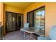Cozy balcony featuring a table and seating with views of the palm tree lined property at 10330 W Thunderbird Blvd # C207, Sun City, AZ 85351