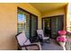 Relaxing balcony with wicker chairs and lush flower arrangements at 10330 W Thunderbird Blvd # C207, Sun City, AZ 85351