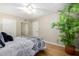 View of bedroom featuring ceiling fan, plant, and closet with mirrored door at 10330 W Thunderbird Blvd # C207, Sun City, AZ 85351