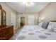 Bedroom featuring carpet flooring, a ceiling fan, a bed, mirrored closet, and wooden dresser at 10330 W Thunderbird Blvd # C207, Sun City, AZ 85351