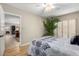 Bedroom view showcasing plant, window with shutters, and doorway to another room at 10330 W Thunderbird Blvd # C207, Sun City, AZ 85351