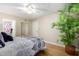 View of bedroom featuring ceiling fan, plant, and closet with mirrored door at 10330 W Thunderbird Blvd # C207, Sun City, AZ 85351