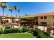 A meticulously landscaped courtyard features shaded seating, a pergola, and lush green lawns at 10330 W Thunderbird Blvd # C207, Sun City, AZ 85351