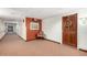 Hallway with a chair, door, and neutral-toned carpet extending along the length of the hallway at 10330 W Thunderbird Blvd # C207, Sun City, AZ 85351