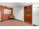 Hallway with a door featuring a wreath, complemented by neutral carpet and a chair at 10330 W Thunderbird Blvd # C207, Sun City, AZ 85351