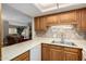 Open kitchen features modern appliances and a view of the living room area at 10330 W Thunderbird Blvd # C207, Sun City, AZ 85351