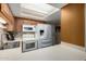 Bright kitchen with white appliances, tile backsplash, and white countertops at 10330 W Thunderbird Blvd # C207, Sun City, AZ 85351