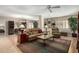 Spacious living room boasts a tan leather sofa and a large, bright window with shutters at 10330 W Thunderbird Blvd # C207, Sun City, AZ 85351