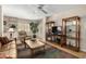 Inviting living room with neutral walls, ceiling fan, and built in storage shelves at 10330 W Thunderbird Blvd # C207, Sun City, AZ 85351