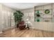 Bright living room area with hardwood floors, indoor plant and built in shelving at 10330 W Thunderbird Blvd # C207, Sun City, AZ 85351