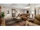 Comfortable living room featuring a tan leather sofa and accent chairs at 10330 W Thunderbird Blvd # C207, Sun City, AZ 85351