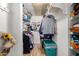 Walk-in closet well-organized with hanging clothes, bags, and storage containers at 10330 W Thunderbird Blvd # C207, Sun City, AZ 85351