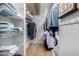 Walk-in closet with shelving units and hanging clothes with hardwood floors at 10330 W Thunderbird Blvd # C207, Sun City, AZ 85351
