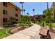 A picturesque walkway meanders through lush landscaping, benches, and mature trees at 10330 W Thunderbird Blvd # C207, Sun City, AZ 85351