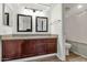 Bathroom with vanity, granite countertop, and a framed mirror, complemented by a shower with a curtain at 1075 E Chandler Blvd # 210, Chandler, AZ 85225