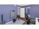 Bedroom featuring purple wall, workout equipment, and a Total Gym poster offering inspiration for exercise at 1075 E Chandler Blvd # 210, Chandler, AZ 85225