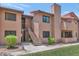 Charming two-story condo with stairs leading to the front entrance at 1075 E Chandler Blvd # 210, Chandler, AZ 85225