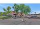 Exterior view of building 1075 featuring mature shade trees and a view of covered parking at 1075 E Chandler Blvd # 210, Chandler, AZ 85225
