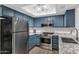 Modern kitchen features stainless steel appliances and sleek granite countertops at 1075 E Chandler Blvd # 210, Chandler, AZ 85225