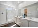 Bright bathroom features a double vanity, large mirror, and a shower over tub at 13529 W Remuda Dr, Peoria, AZ 85383