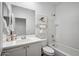 Well-lit bathroom showcases a vanity with sink and a toilet next to a shower and bath combo at 13529 W Remuda Dr, Peoria, AZ 85383