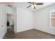 Neutral bedroom featuring tiled floors and large window letting in plenty of light at 13529 W Remuda Dr, Peoria, AZ 85383