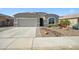 Charming single-story home featuring low-maintenance desert landscaping and a two car garage at 13529 W Remuda Dr, Peoria, AZ 85383