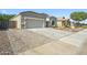 Charming house featuring a well-maintained front yard, complemented by a two-car garage at 13529 W Remuda Dr, Peoria, AZ 85383