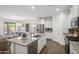Bright, open kitchen with granite countertops, stainless steel appliances, and wood flooring at 13529 W Remuda Dr, Peoria, AZ 85383