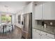 Charming kitchen with stainless steel refrigerator and a cozy dining area with decorative chandelier at 13529 W Remuda Dr, Peoria, AZ 85383