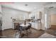 Bright kitchen with stainless steel appliances, granite countertops and table with seating at 13529 W Remuda Dr, Peoria, AZ 85383
