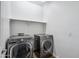 Contemporary laundry room with front loading washer and dryer and built in shelving at 13529 W Remuda Dr, Peoria, AZ 85383