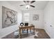 Home office with natural light, modern artwork, and a practical workspace creates a productive environment at 13529 W Remuda Dr, Peoria, AZ 85383