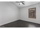 Bright bedroom with window and dark wood look tile at 15131 W Melissa Ln, Surprise, AZ 85374