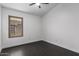 Bright bedroom with window and dark wood look tile at 15131 W Melissa Ln, Surprise, AZ 85374